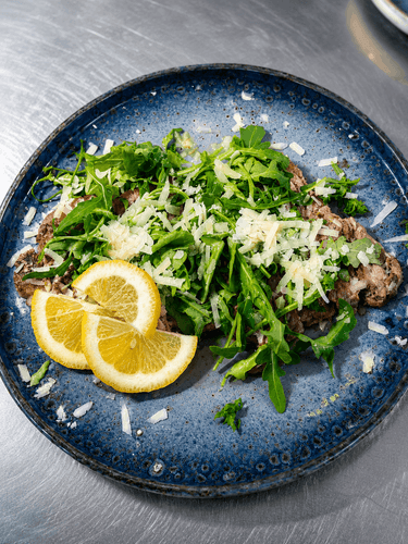 Beef tagliata with rocket and Parmigiano